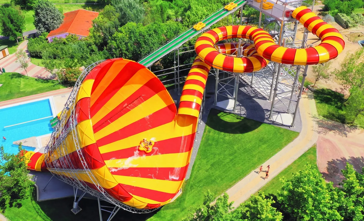 Aerial view of a Pendulum funnel water slide with riders in a raft