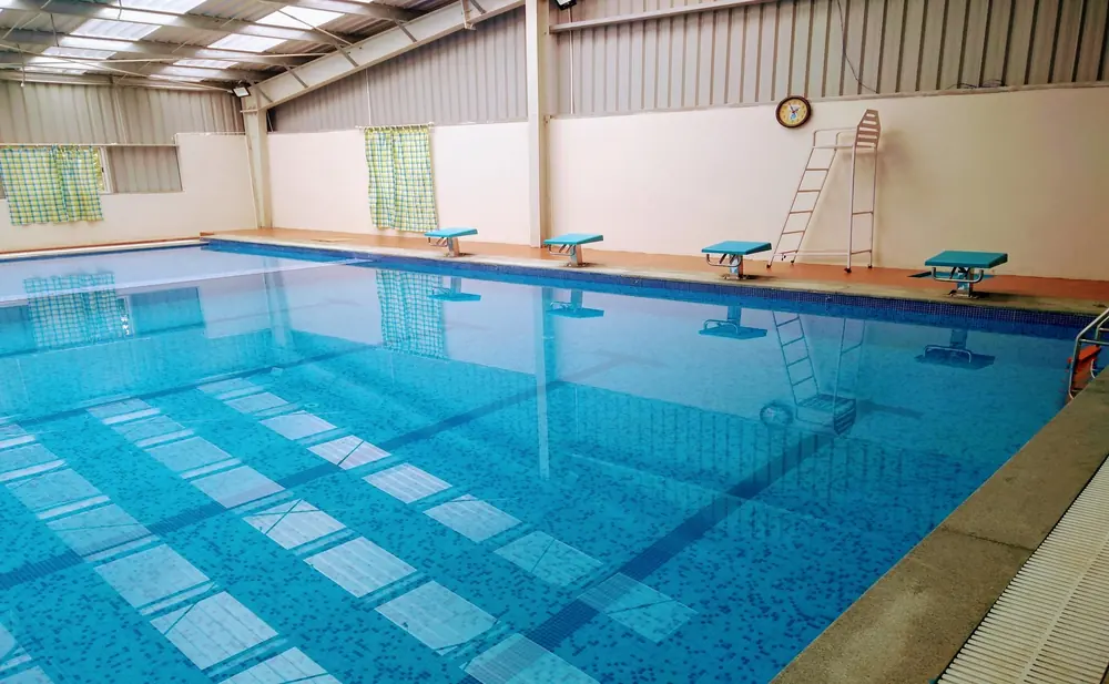 Starting blocks along the deep end of an indoor competition pool